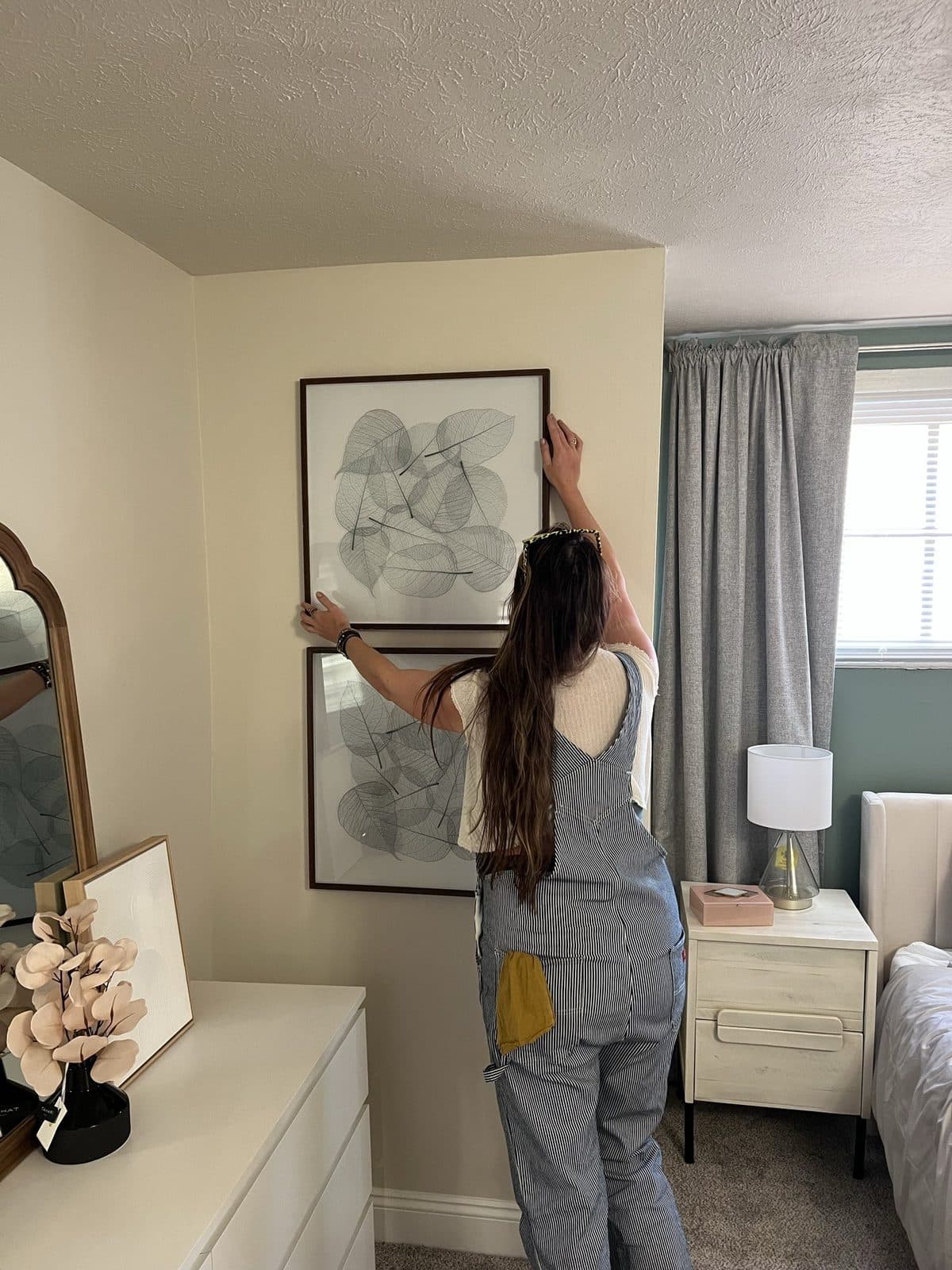 Hanging the art, overalls on
