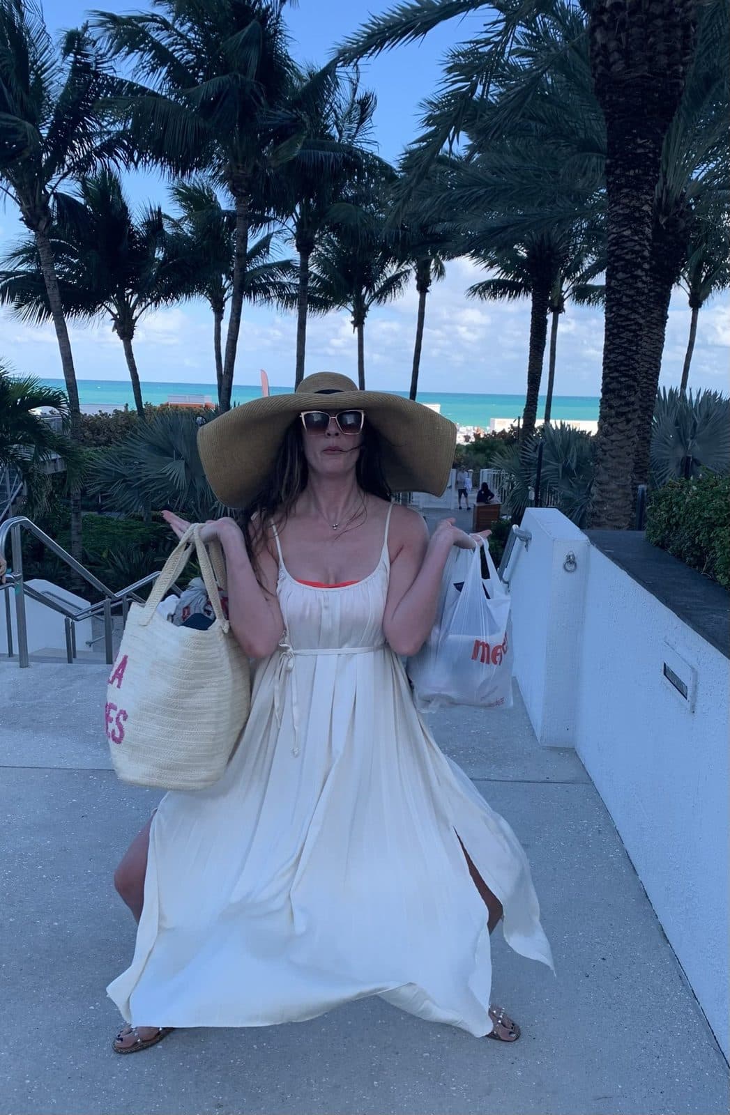 Palms, a big hat, the beach