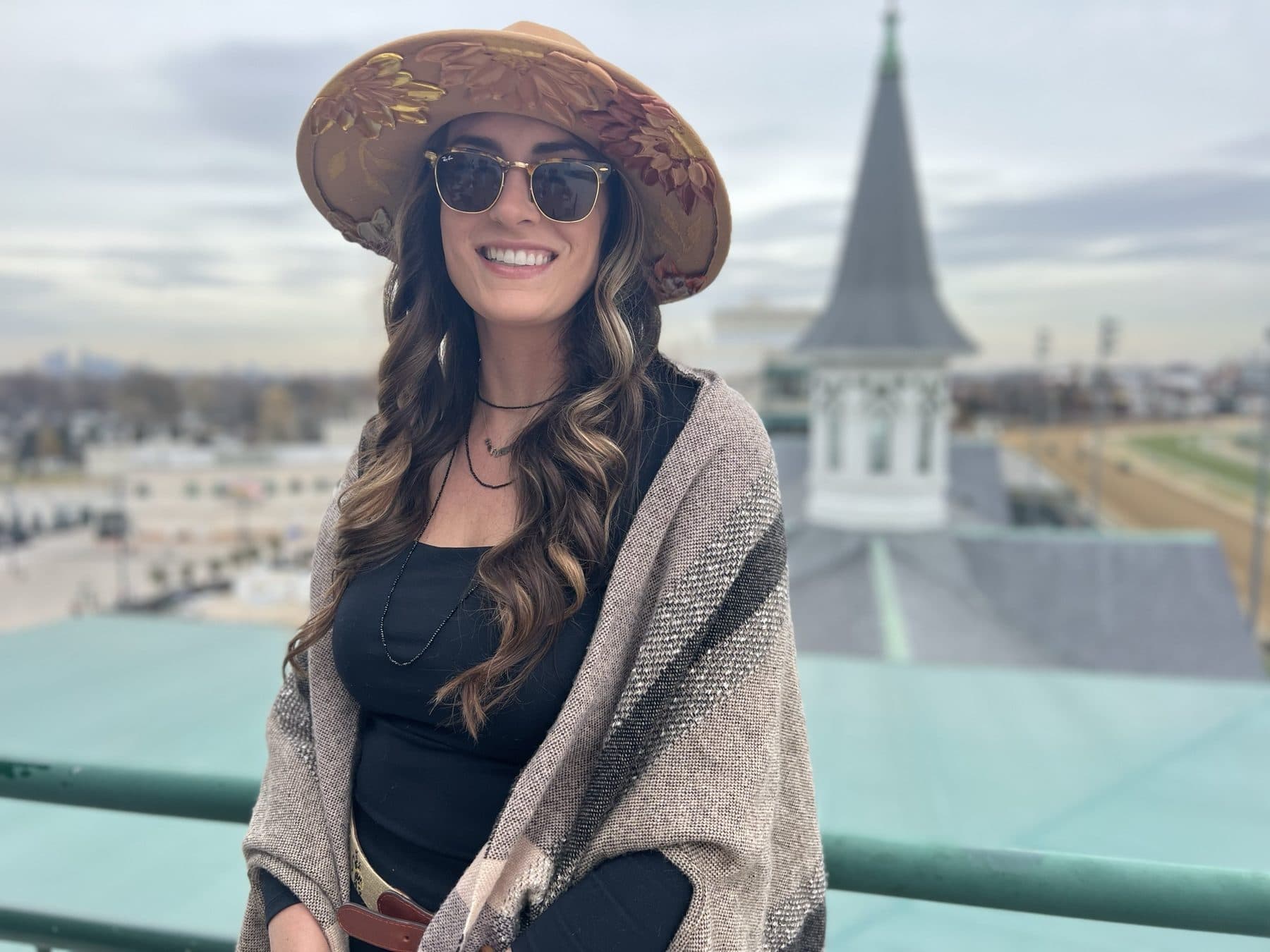 Straw hat and sunglasses on the balcony at Churchill Downs.