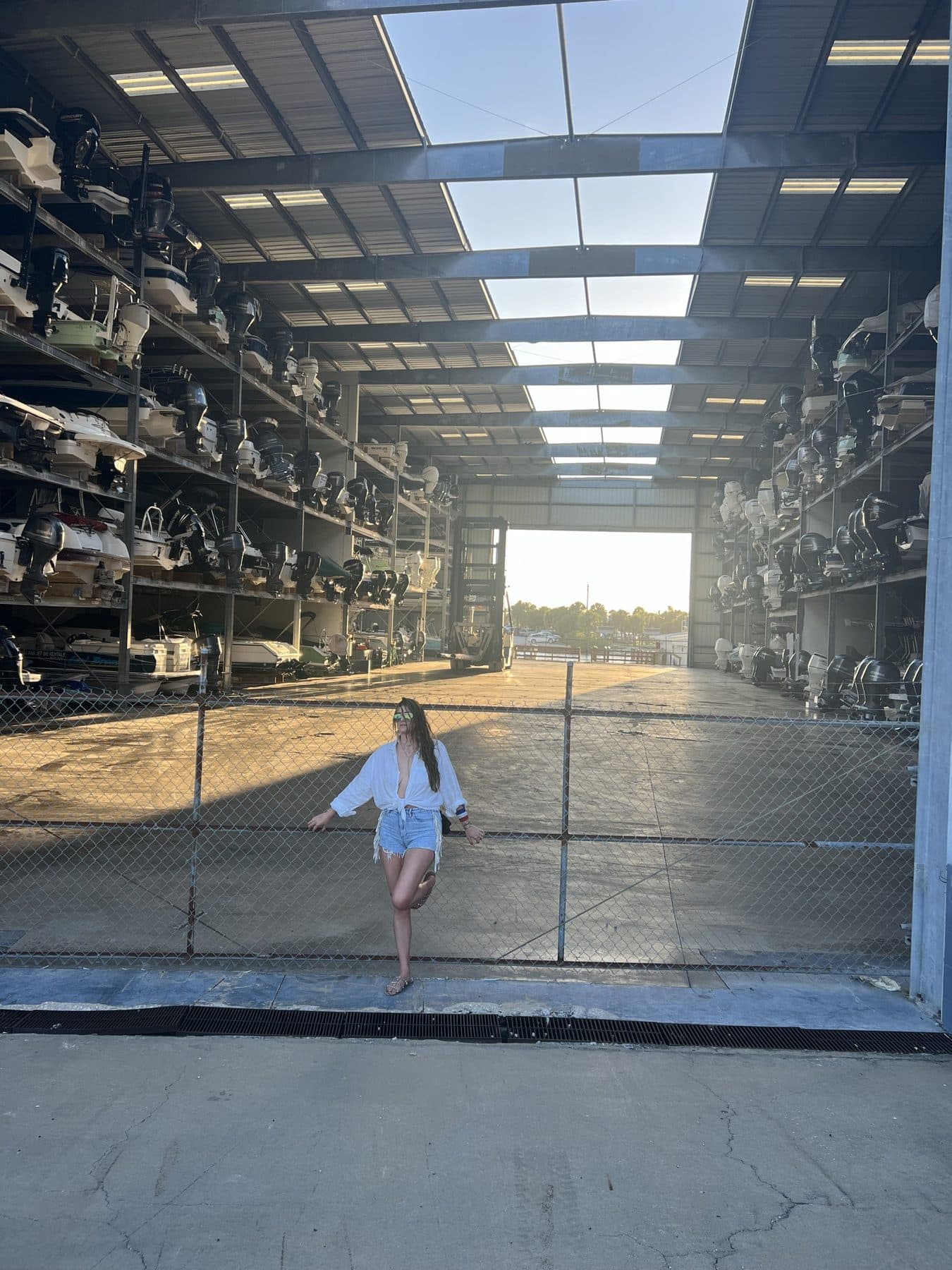 Alone on the floor of a vast warehouse, light pouring through the wall.