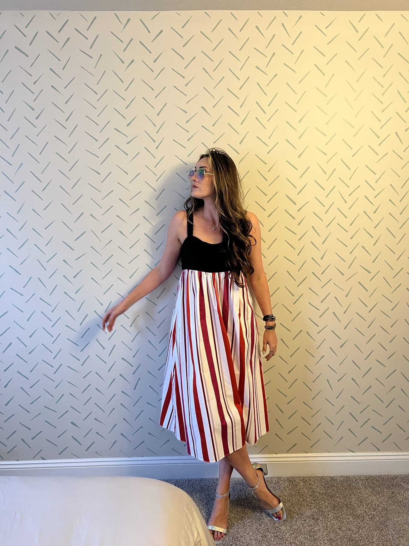 Striped skirt on a diamond-plate floor, shot from above.