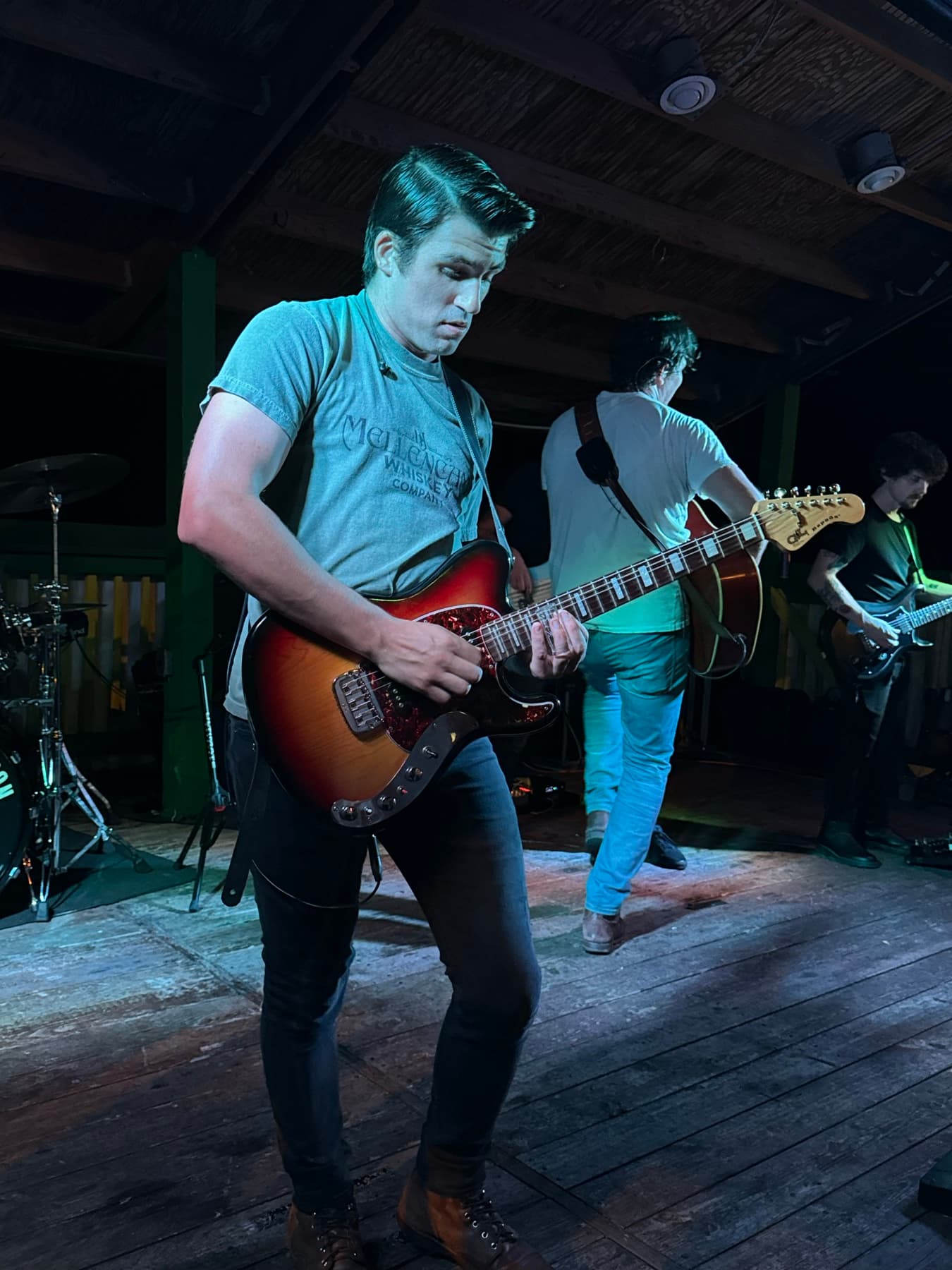 An artist brand shot with a guitar in hand.