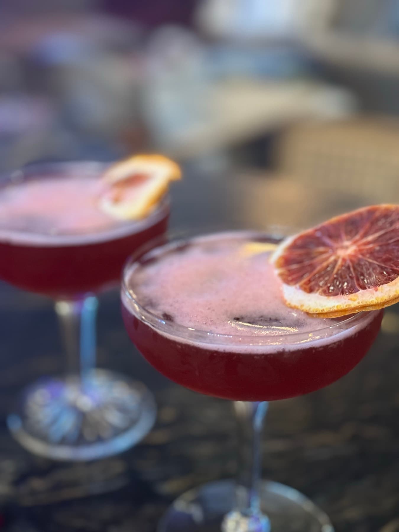 Grapefruit cocktails, rims and garnish in focus.
