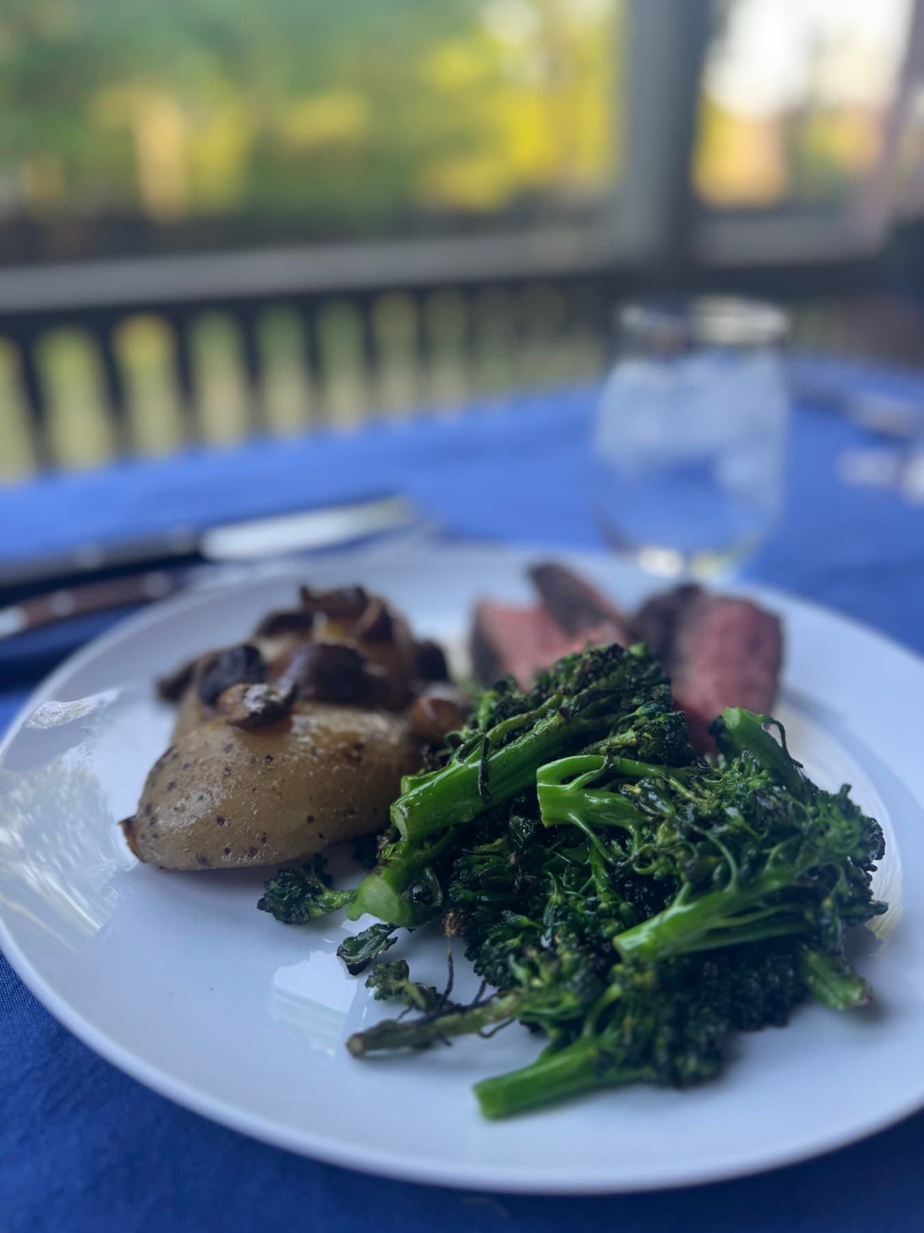 A plated entrée, seared fish and bright greens.