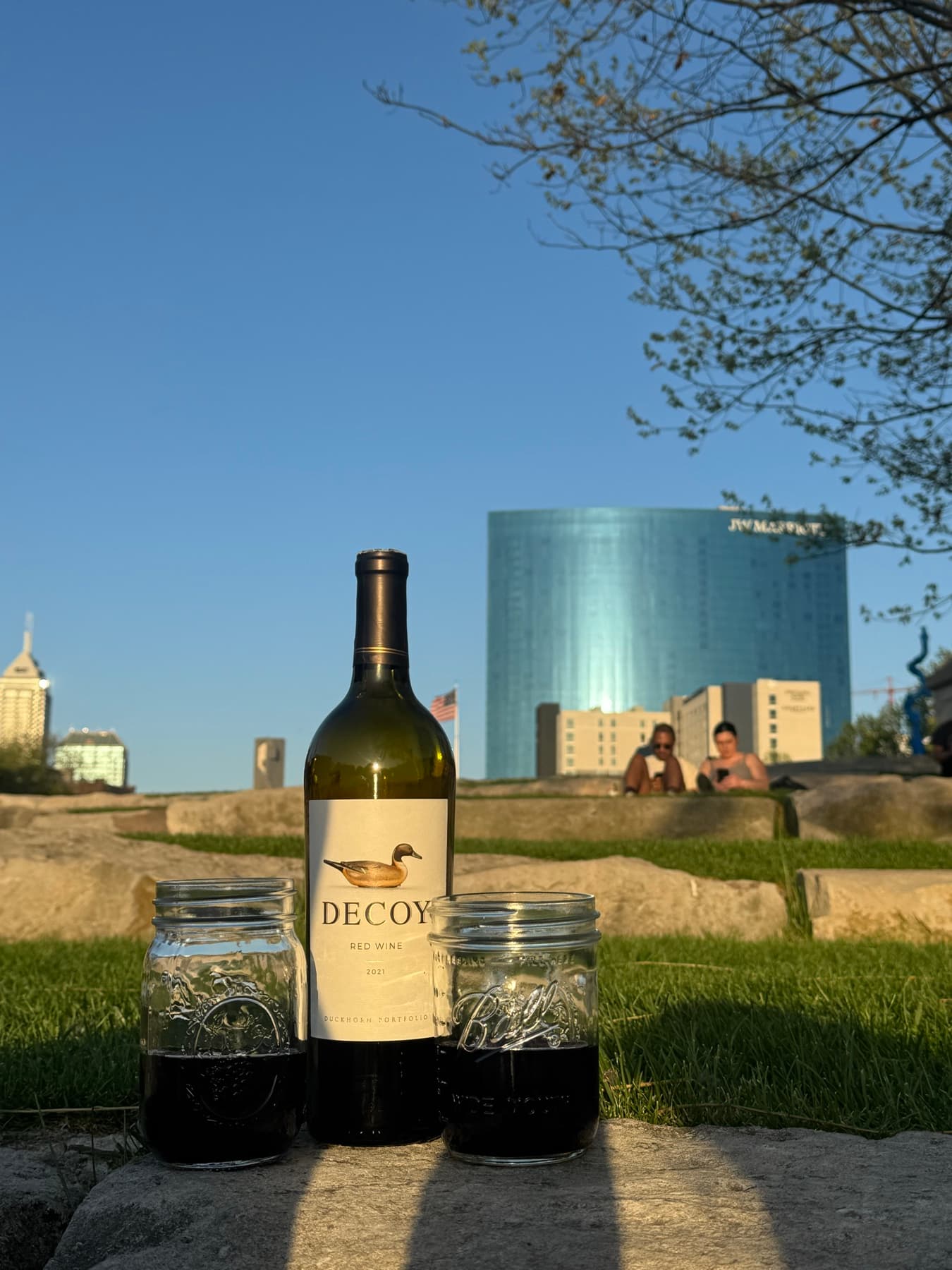 A bottle staged at the waterline at golden hour.
