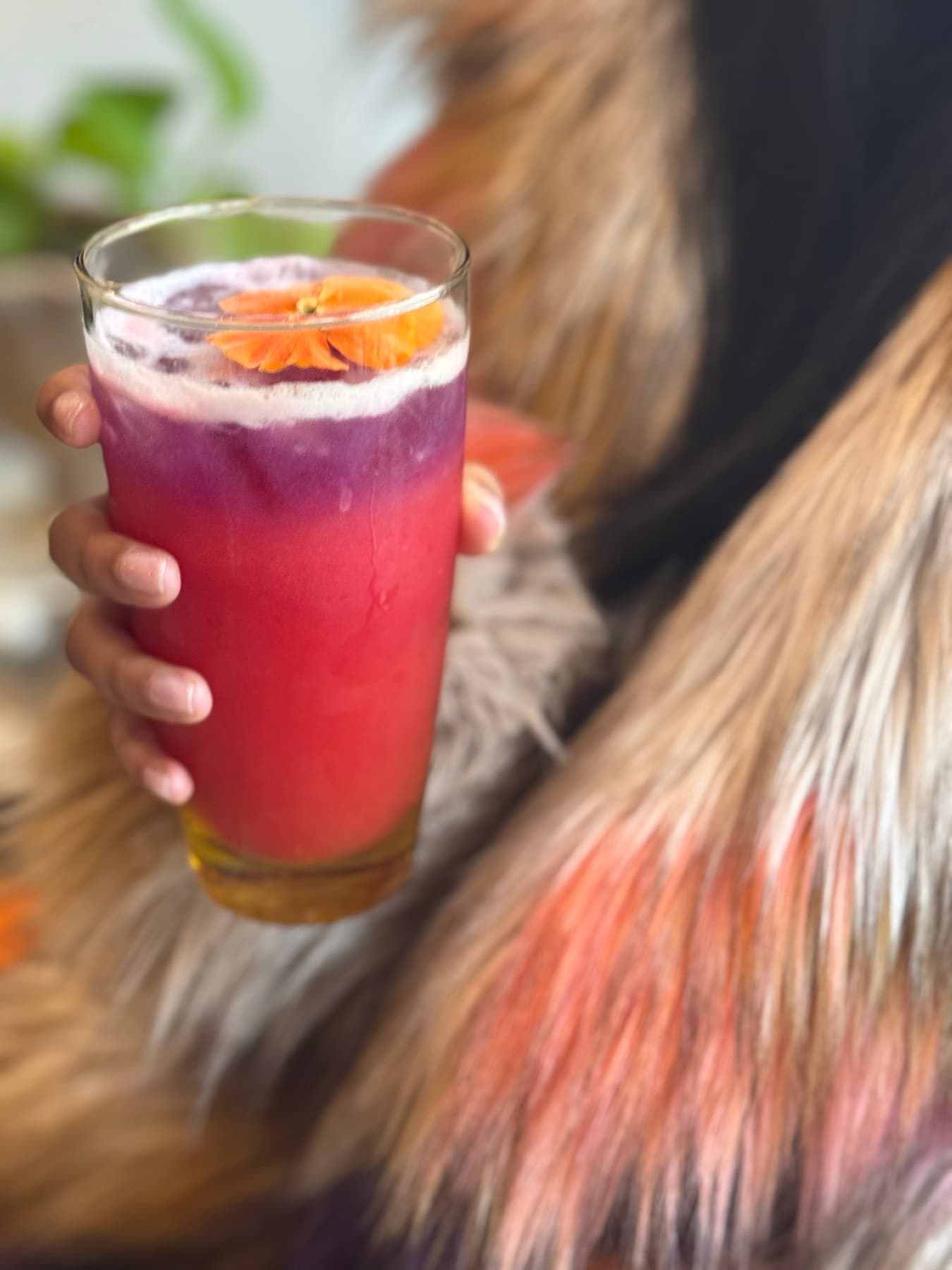 A red cocktail styled on texture and fur.