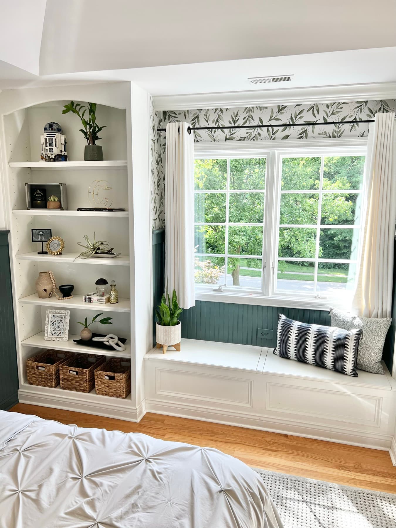 The window seat styled with cushions and storage below.