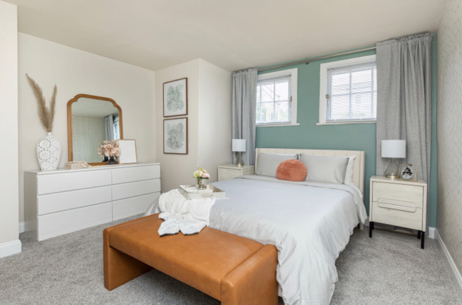Primary bedroom after, upholstered bed, leather bench, and a teal accent wall with a herringbone feature.