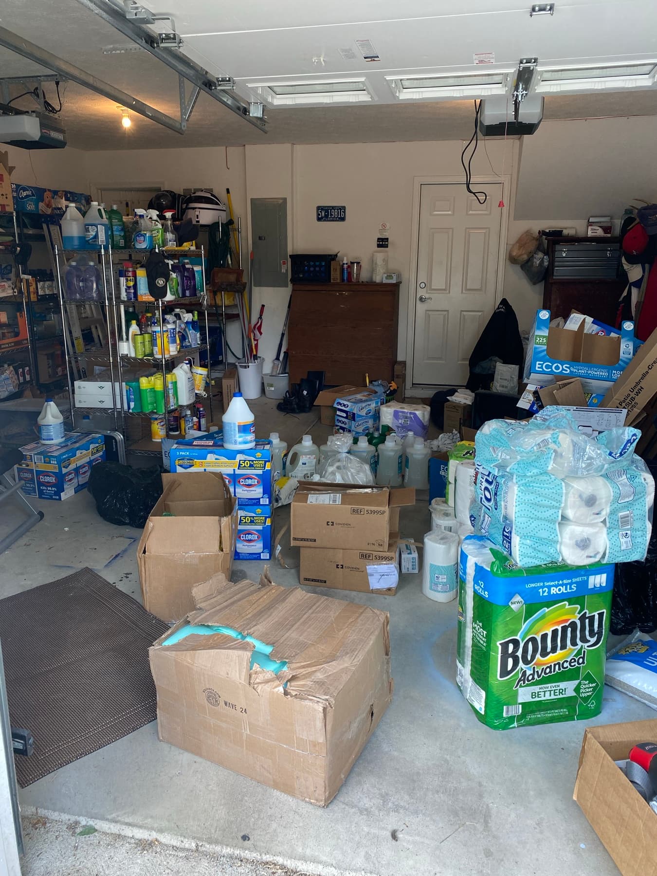 Before, an overstuffed garage with boxes and clutter across the floor.