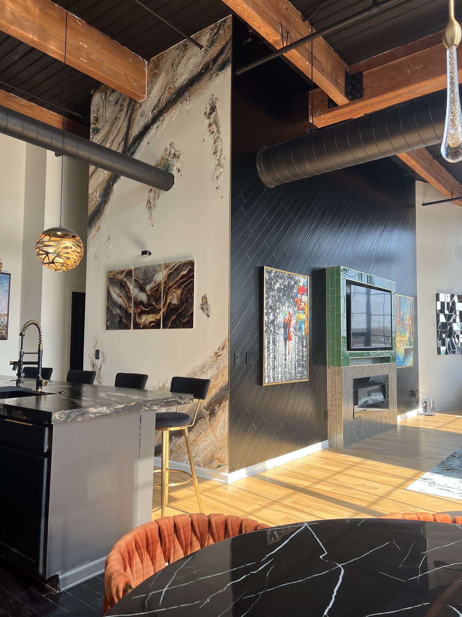 Wider room context, the feature wall anchoring a black-marble table and floor-length drapery.