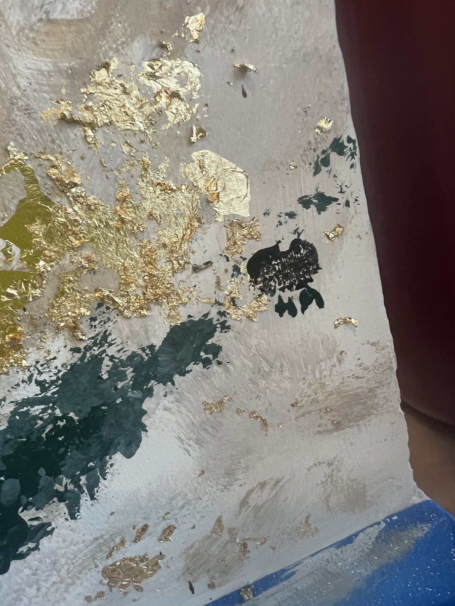 Close detail of the finish, molten gold and teal pooling through black and cream.