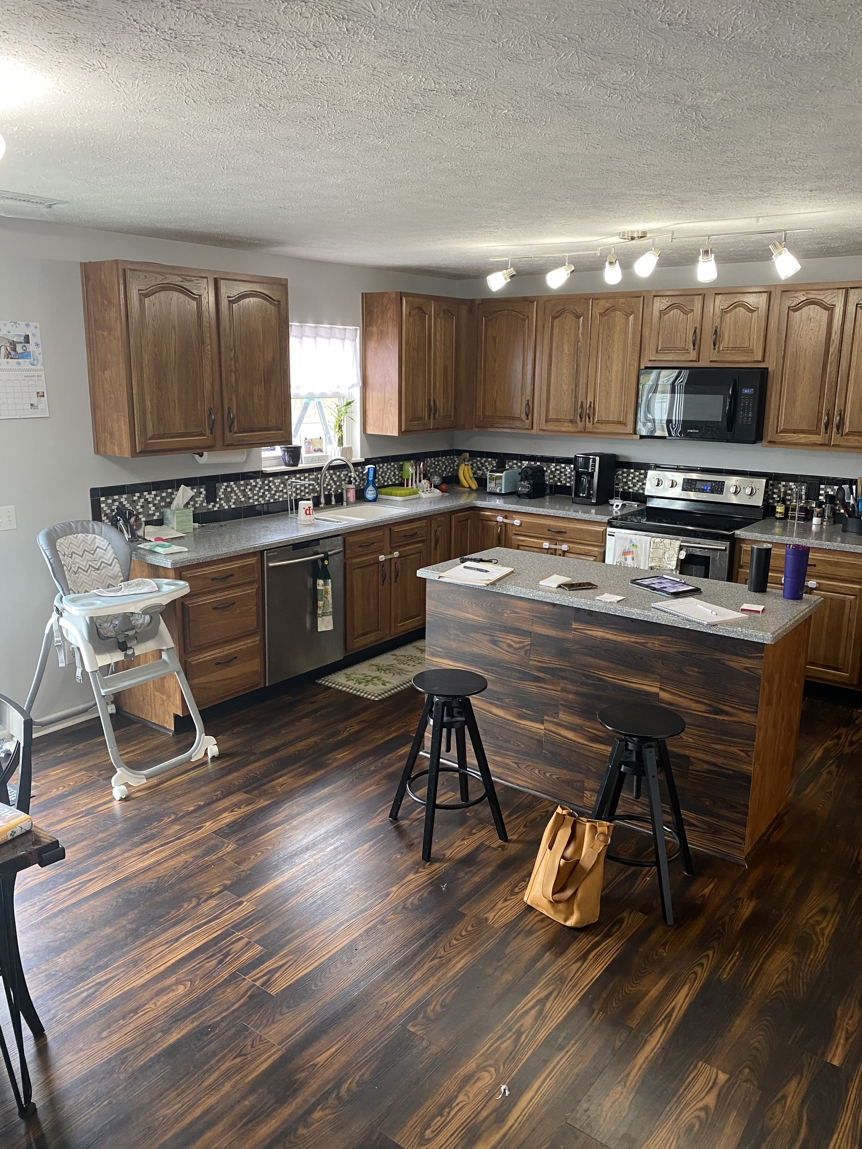 Before, a dark kitchen with heavy, dated wood cabinetry.