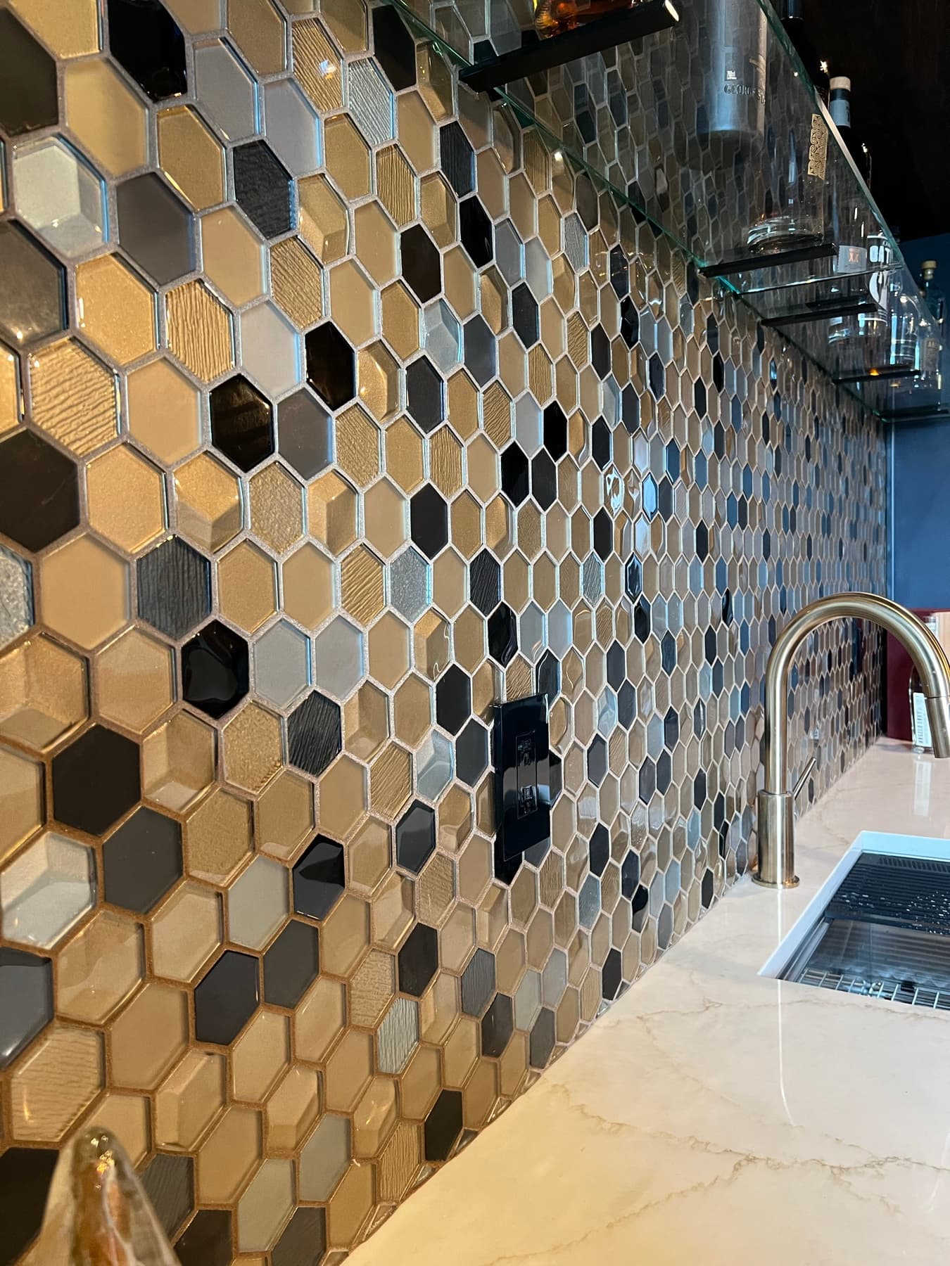 The hand-set hexagonal floor running the length of the room.