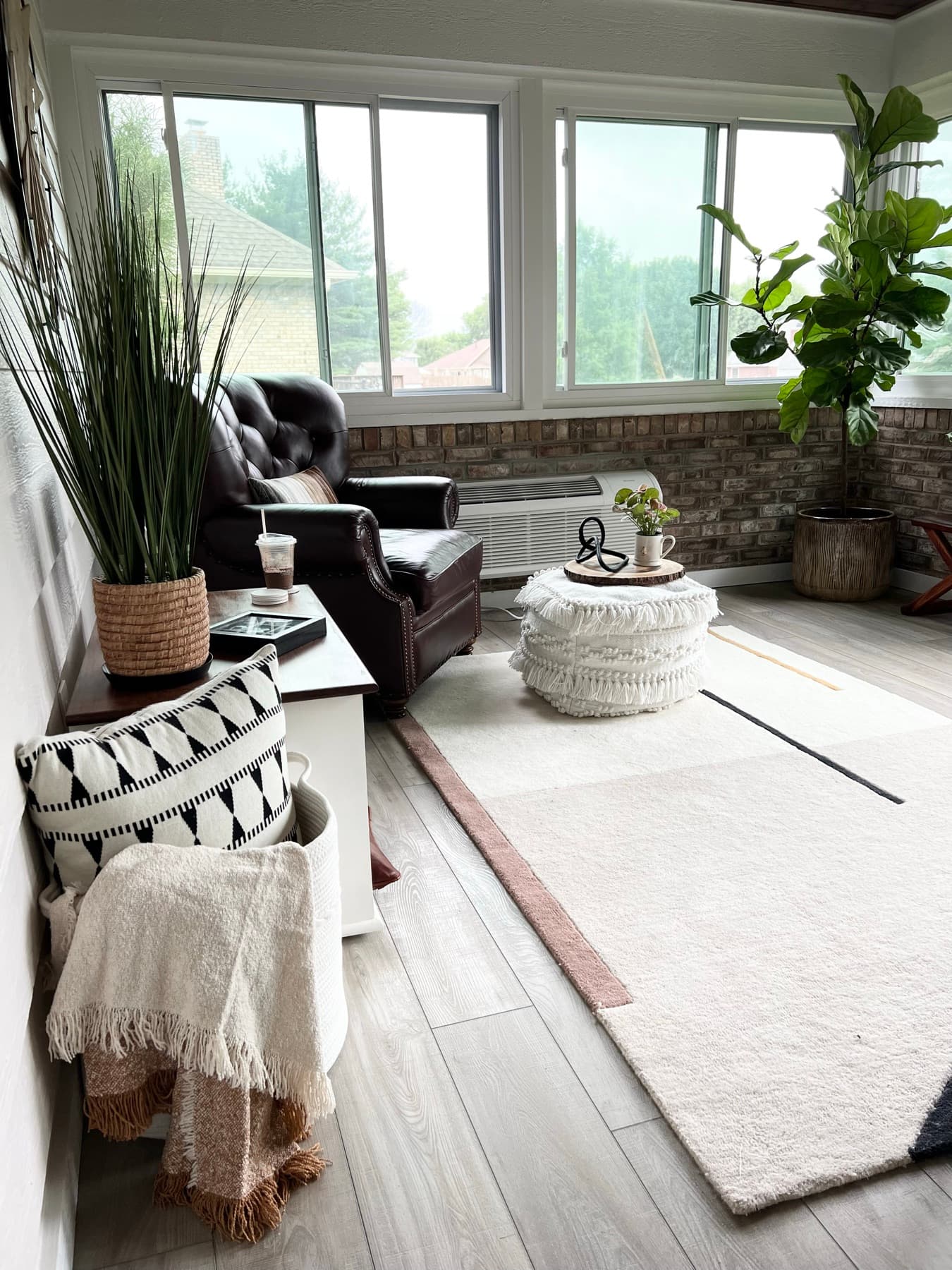 Morning light across the seating and layered rug.